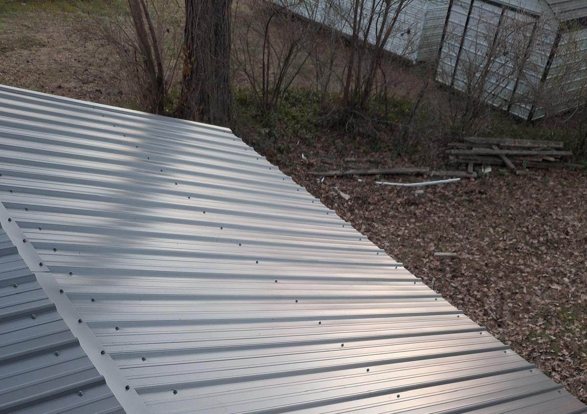metal roof shingles Louisville tn green standing-seam metal roof installed on a residential property