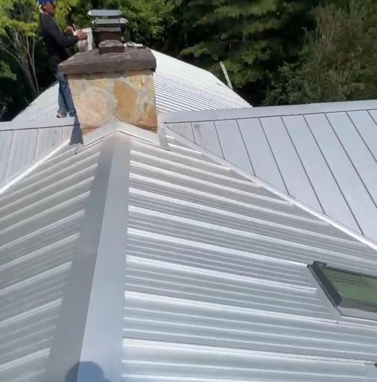 completed roofing materials aligned around roof transitions