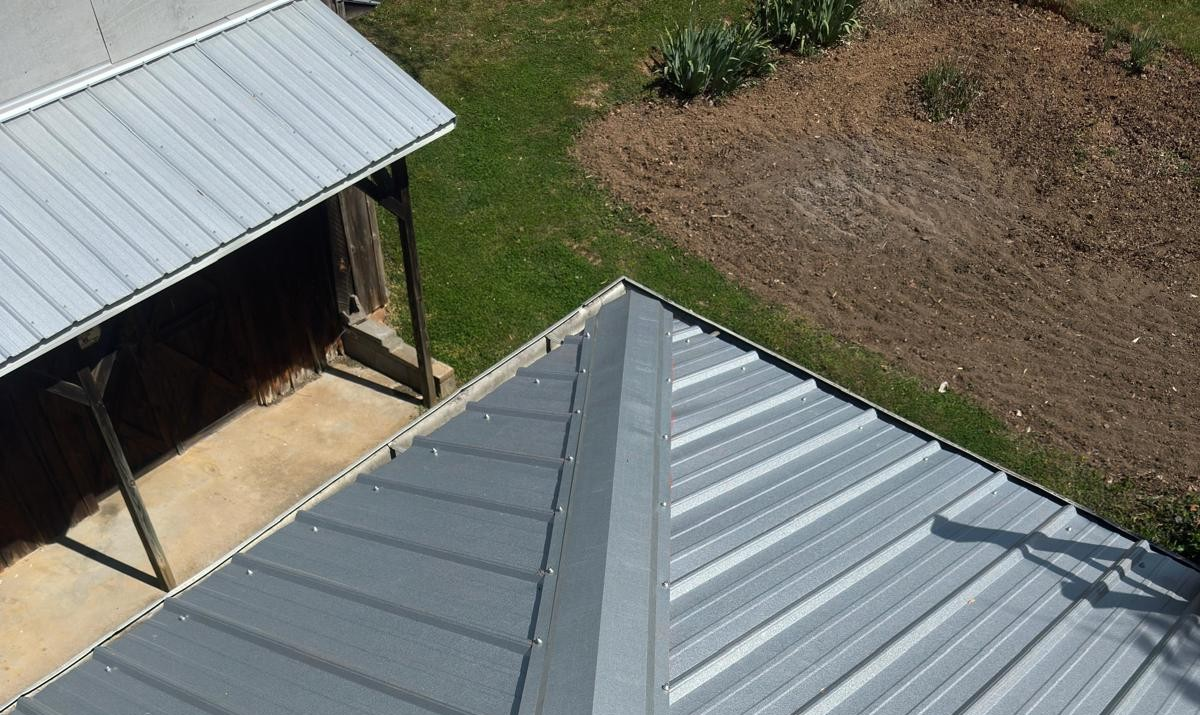 Completed metal roofing improvement with renewed panels and exterior transitions