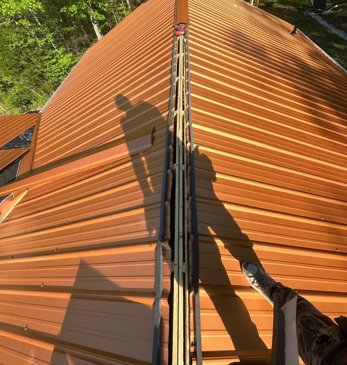 metal roofers Townsend tn page showing completed roofing near a wooded mountain setting