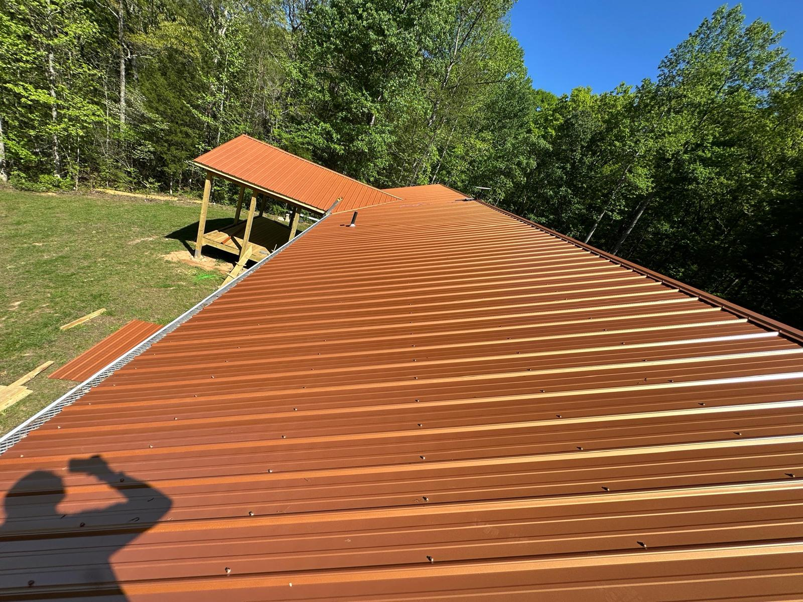 Metal roofers Clinton TN installing roofing materials on a residential property
