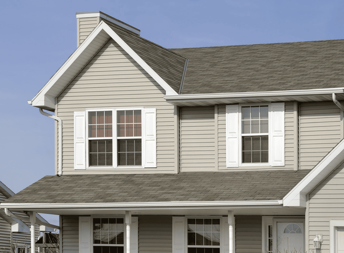 completed roof edge and valley detail above a brick exterior wall